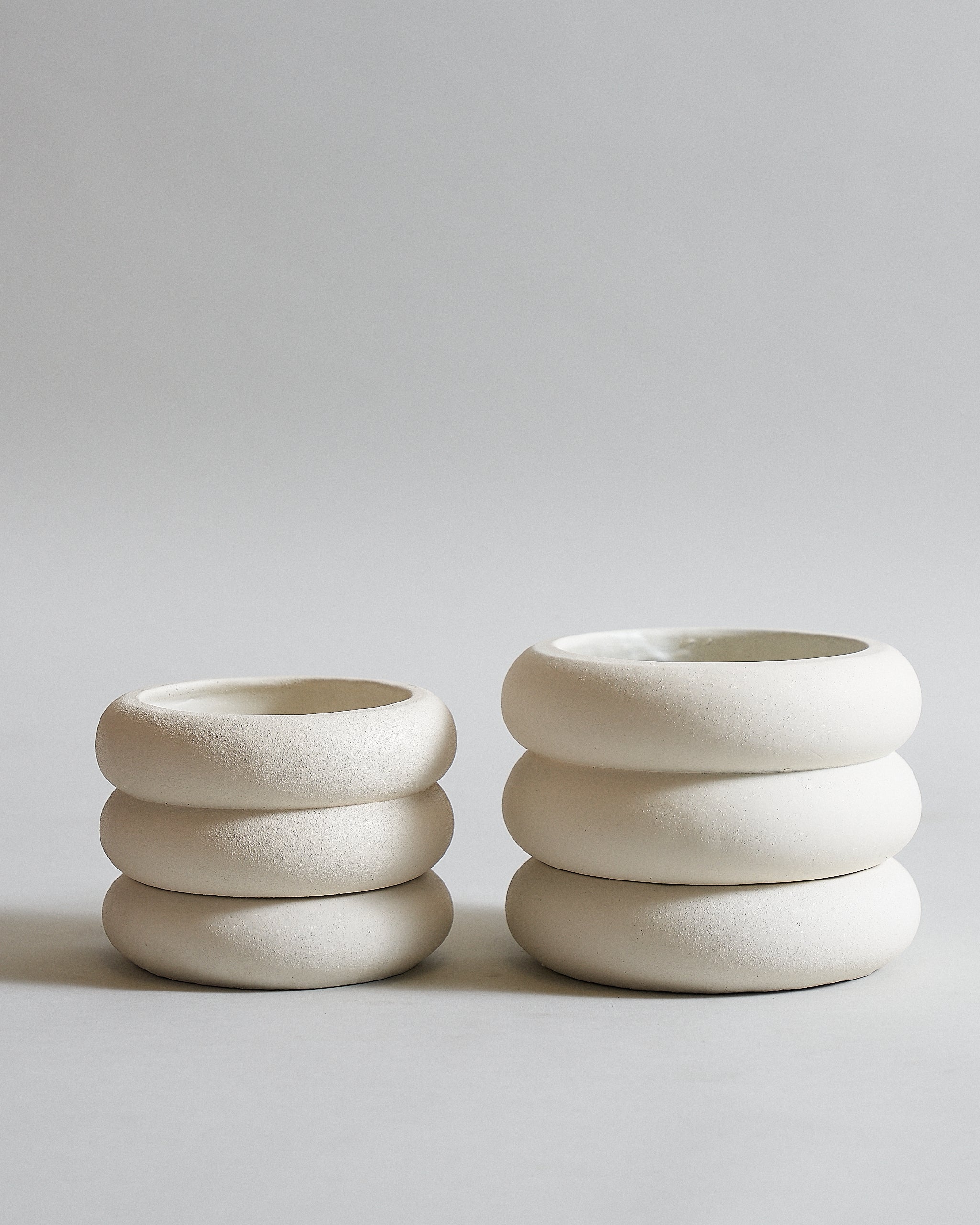 White concrete pot for indoor plants with a layered circular design